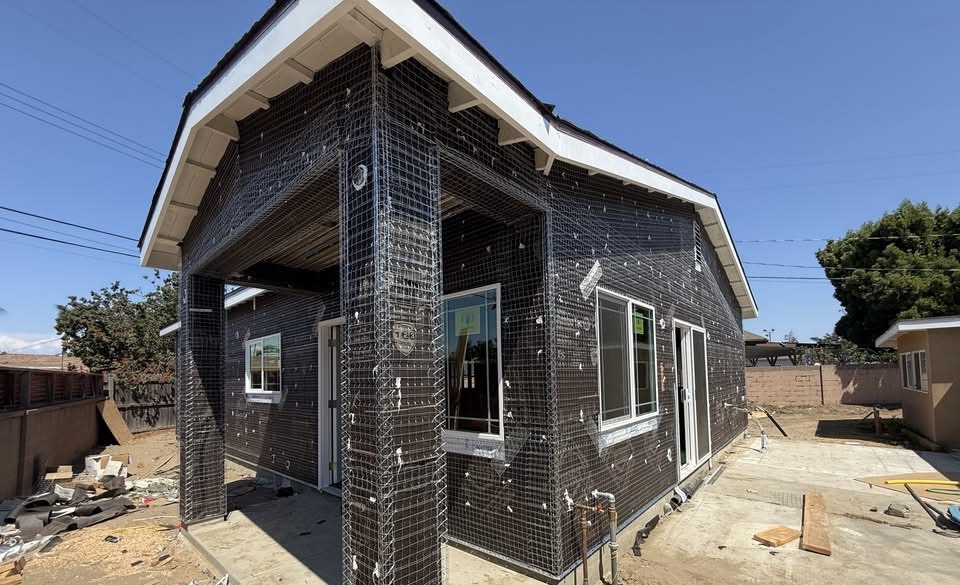 ADU construction — exterior lath and wire mesh stage, pre-stucco