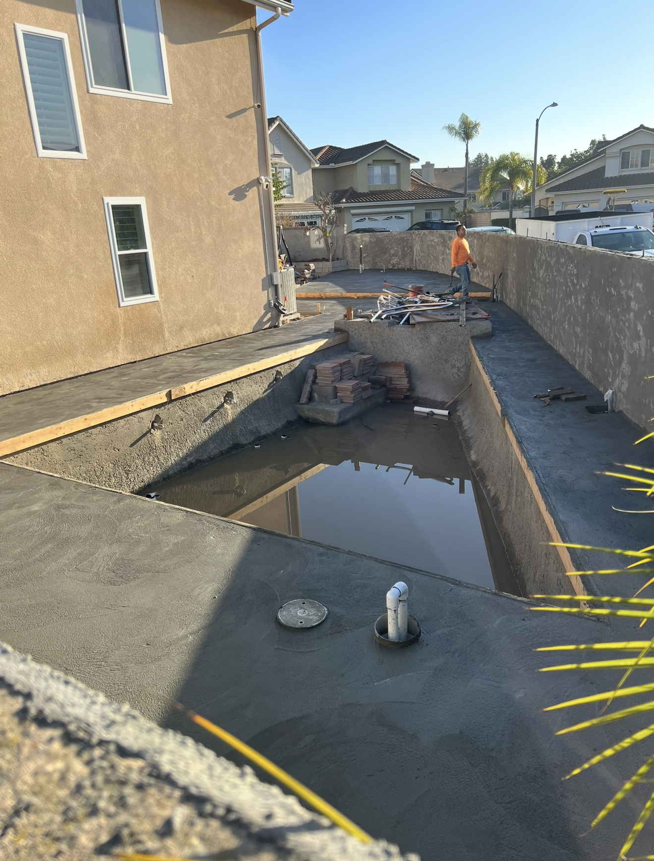 Concrete sub-slab poured as the structural base for large-format porcelain pavers on a Southern California patio