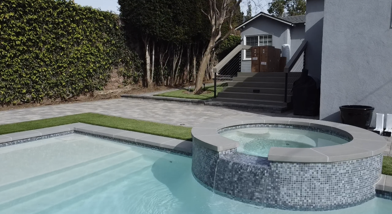Finished pool with raised spa, pavers and turf